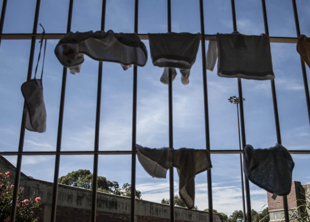 Harsh reality: Children’s clothes dry on prison bars
